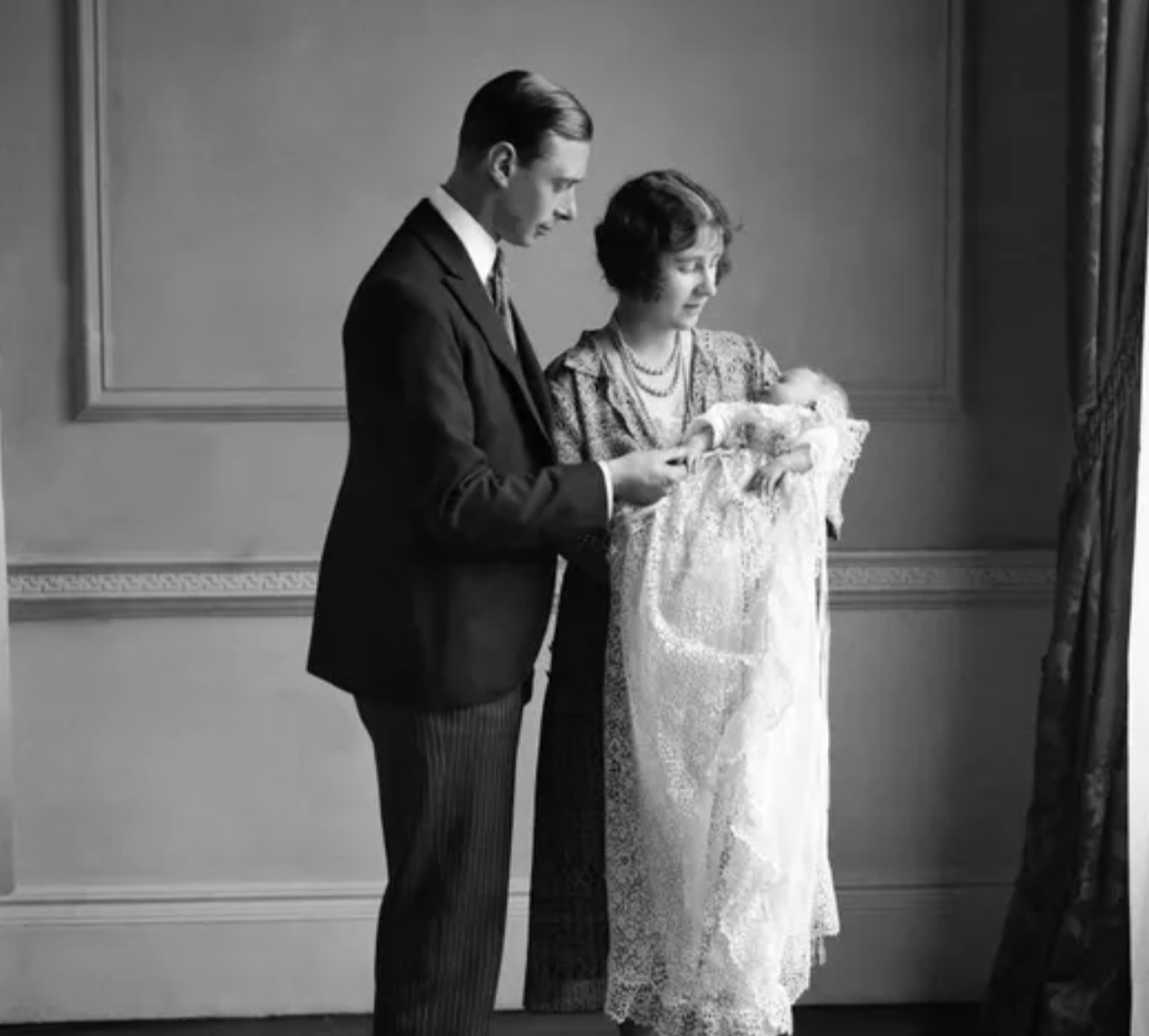 The Queen Mother (then the Duchess of York) with her husband, King George VI (then the Duke of York), and their daughter Elizabeth II at her christening in May 1926. Credit to Getty Images